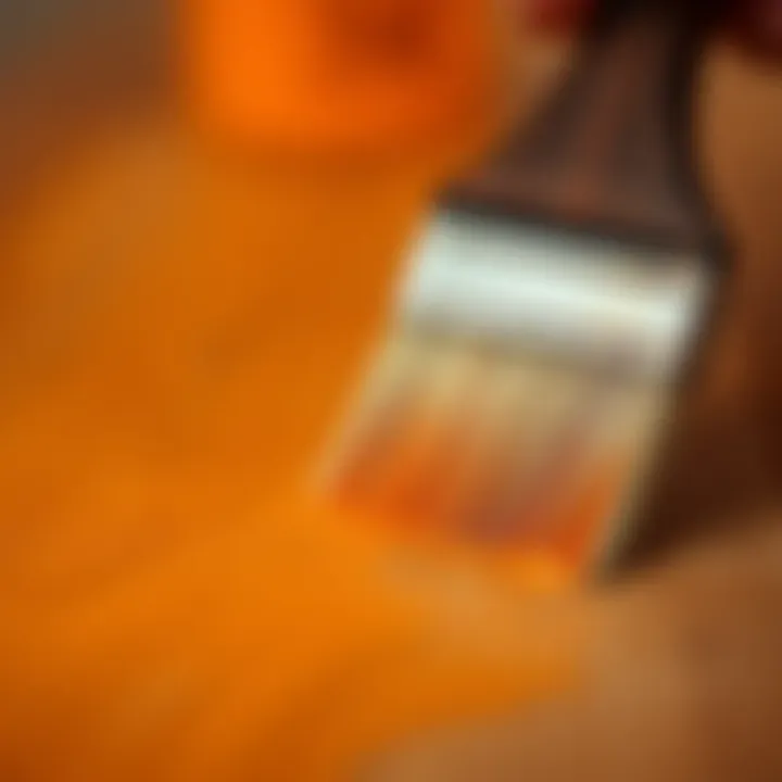 A close-up of a brush applying paint on a wooden surface