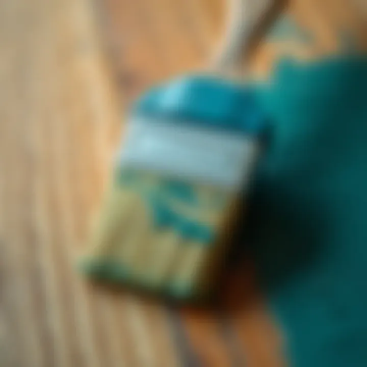 A close-up of a brush applying paint on a wooden surface