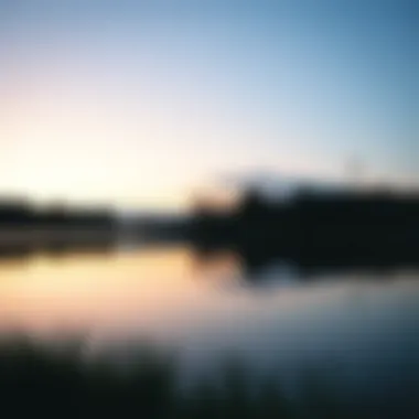 A tranquil lake reflecting the sky at dawn