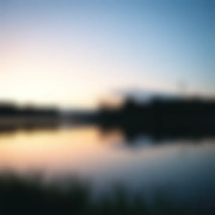 A tranquil lake reflecting the sky at dawn